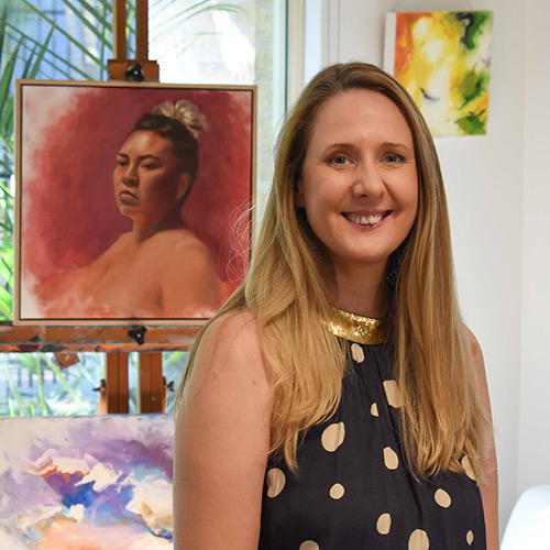 Therase Campbell Fine Artist in front of a painted portrait